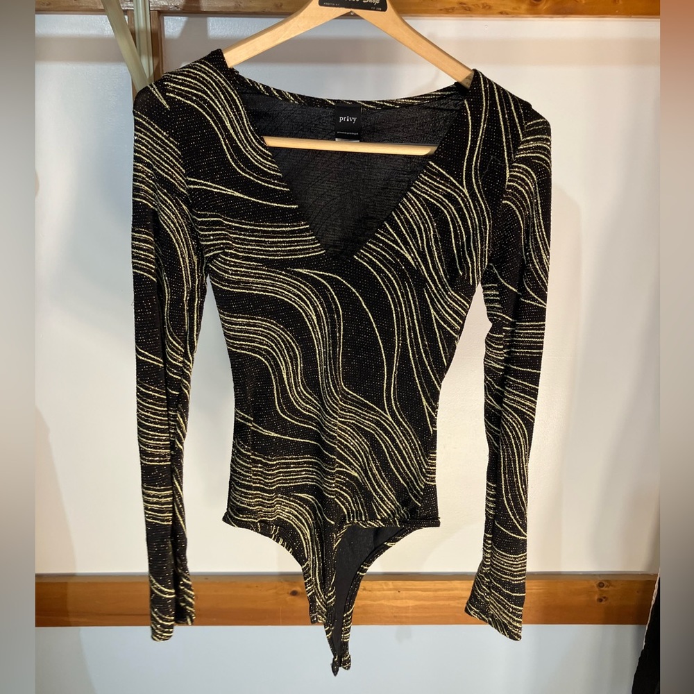 Black and gold sparkly gymnastics leotard